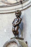 Manneken Pis Little man Pee or le Petit Julien, a very famous bronze sculpture landmark in Brussels photo