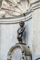 Manneken Pis Little man Pee or le Petit Julien, a very famous bronze sculpture landmark in Brussels photo