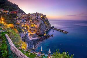 Colorful cityscape of buildings over Mediterranean sea, Europe, Cinque Terre in Italy photo