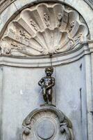 Manneken Pis Little man Pee or le Petit Julien, a very famous bronze sculpture landmark in Brussels photo