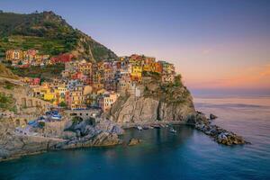 Colorful cityscape of buildings over Mediterranean sea, Europe, Cinque Terre in Italy photo