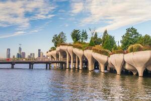 Cityscape of downtown Manhattan skyline with the Little Island Public Park in New York City at sunrise photo