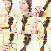 a woman is doing a braid in her hair photo