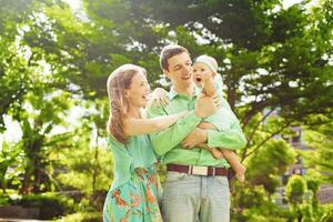 contento familia con bebé en parque foto