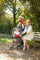 a family with a baby in a stroller photo