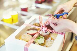 Hand packing many kinds of cupcakes as a present for a wedding or a birthday photo