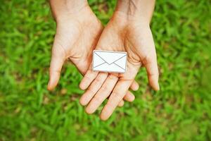 hands holding an envelope with a letter on it photo