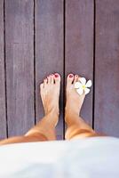 instagram style photo of bare feet standing on a floor. Top view. Filter applied