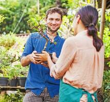 a man and woman standing in front of a garden photo