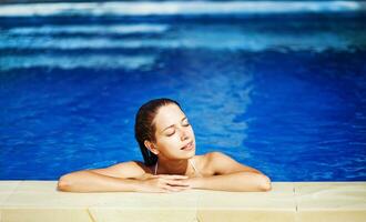 Beautiful woman on the swimming pool photo