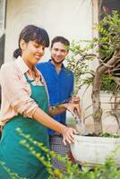 a man and woman standing in front of a garden photo