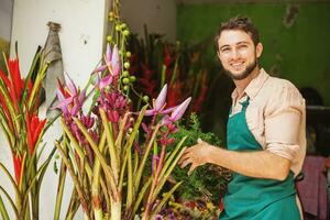 a man is standing in front of a flower shop photo