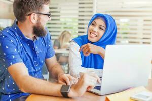 a man and woman in blue headscarves working together photo