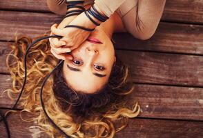 a woman laying on her stomach with her hands on her head photo