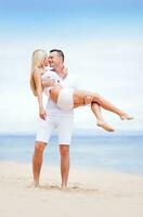 Happy couple on the beach photo