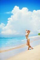 a woman in a bikini on the beach photo