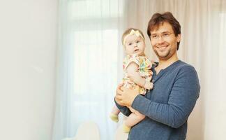 a man holding a baby in his arms photo