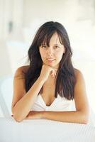 a woman sitting on a white chair photo