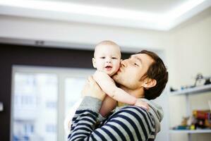 a man holding a baby in his arms photo