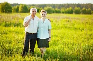 Beautiful happy couple in a field photo