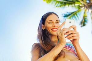 Woman on the phone at the beach photo