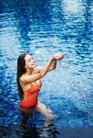 Beautiful woman on the swimming pool photo