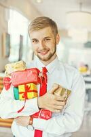 Businessman holding Xmas gifts photo