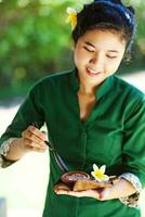 Asian woman serving local food photo