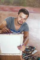 Young man painting photo