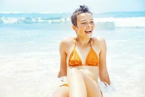 Beautiful young woman enjoying the beach photo