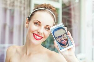 a woman holding a glass of orange juice and a selfie photo