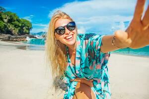 Beautiful young woman enjoying the beach photo