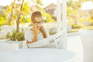 Woman reading newspaper photo