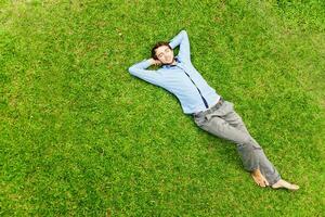 Man laying on the grass photo