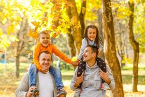 family with two children in autumn park photo