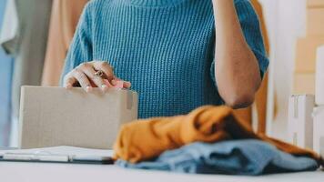 une peu finition touche et ça va être prêt. coup de une Jeune mode designer travail sur une vêtement pendaison plus de une mannequin. video