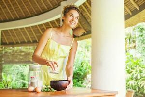 Portrait of a happy caucasian woman using natural secrets to do a skin care photo