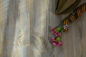 Military cap, airplane, and badge on a Saint George ribbon. photo