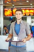 a man holding a tray of food photo