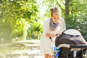 a woman pushing a stroller with a baby in it photo