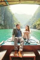 a man and woman sitting on a boat photo