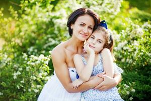 a woman and her daughter are posing for a photo in the grass