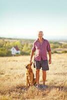 an older man and his dog in a field photo