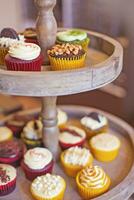 a wooden tray with cupcakes on it photo