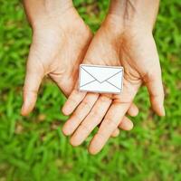 hands holding an envelope with a white envelope photo