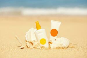 sunscreen, sunscreen, and a tube of sunscreen on the beach photo