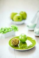 a green plate with a green apple, a green shoe and a green bow photo