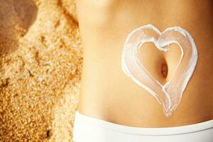 a woman's stomach with a heart drawn on it photo