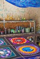 a table with a lot of colorful paintings on it photo