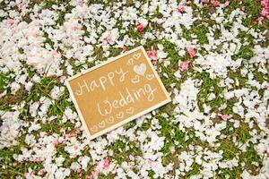 wedding card on the ground with flowers photo